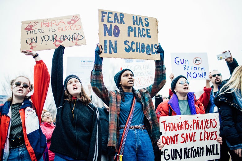 Demonstrators hold signs during a ‘lie-in’ demonstration supporting gun control reform near the White House on Monday in Washington.